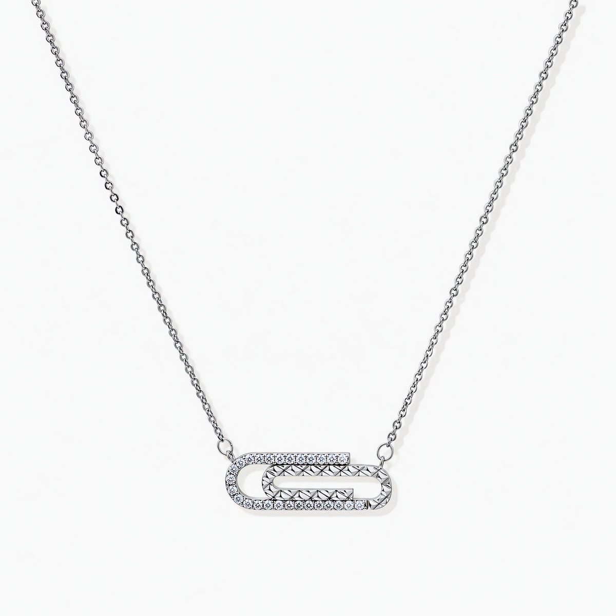White gold plated necklace with dual-frame geometric pendant featuring crystal pavé border on pale background.
