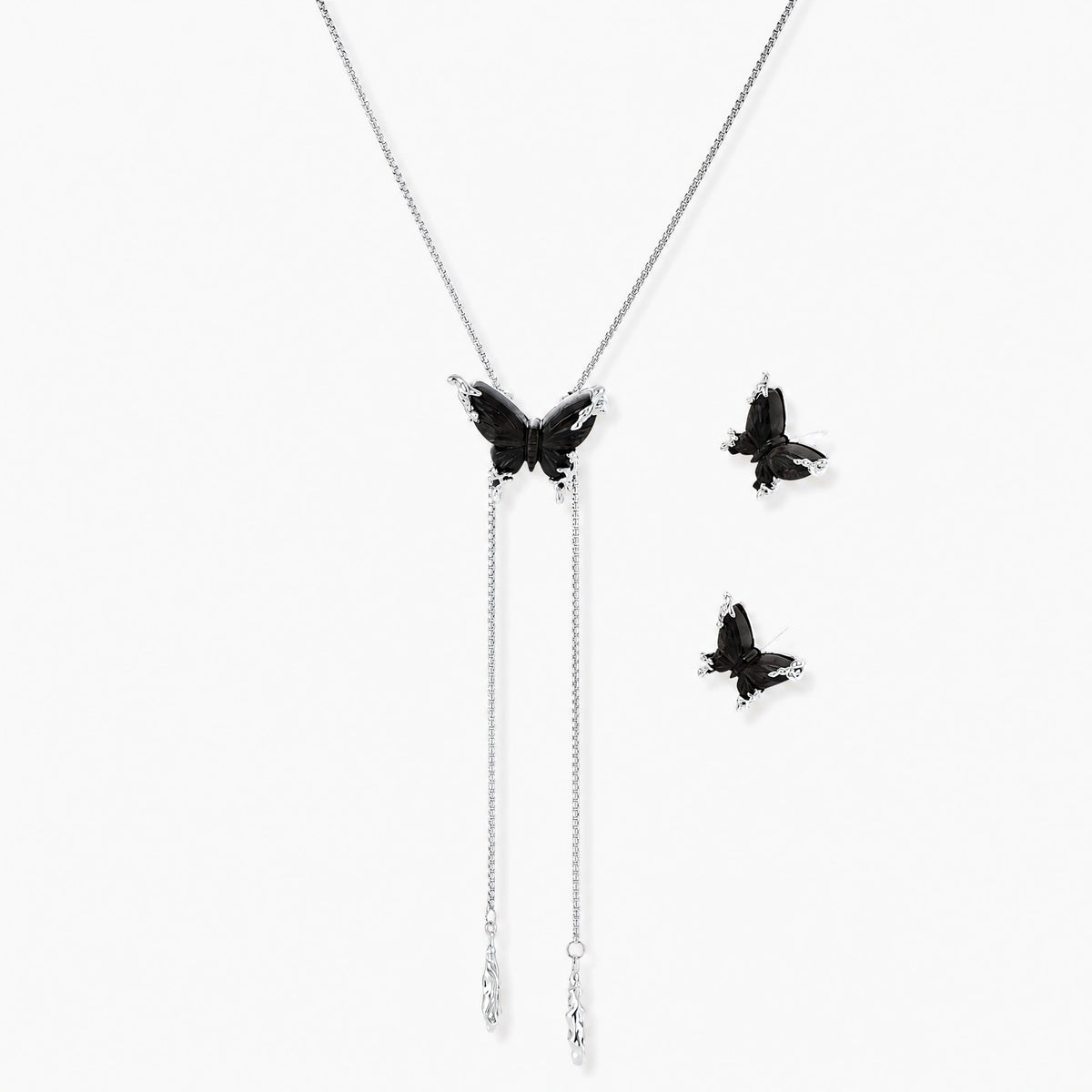 Dark wood butterfly earrings and necklace with silver chain accents on white background, showing natural grain texture.