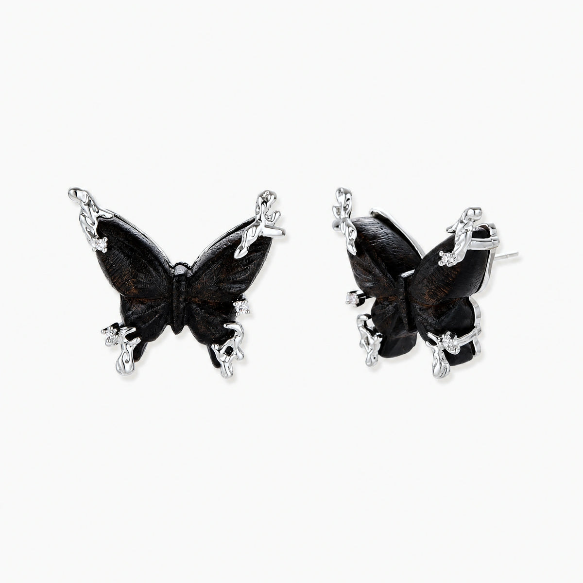 Dark wood butterfly earrings and necklace with silver chain accents on white background, showing natural grain texture.