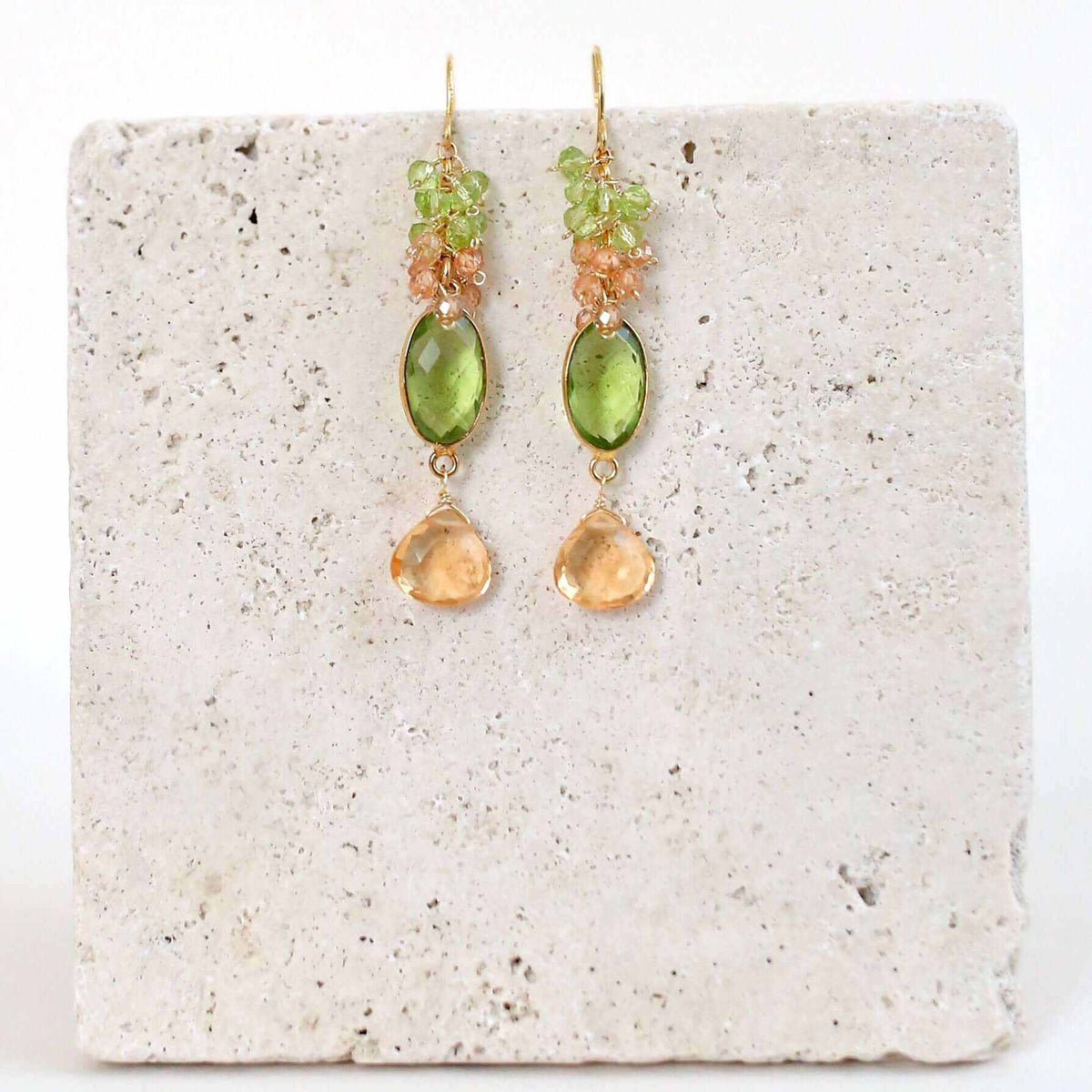 Bezel Cluster EarringsDripping in gems, these long gemstone drop earrings are a handmade combination of beautiful bezel set stones and clusters of gems.- 2.5" long- French hooks- 14k goldEarringsPARKEN JEWELRYVettedArcBezel Cluster Earrings