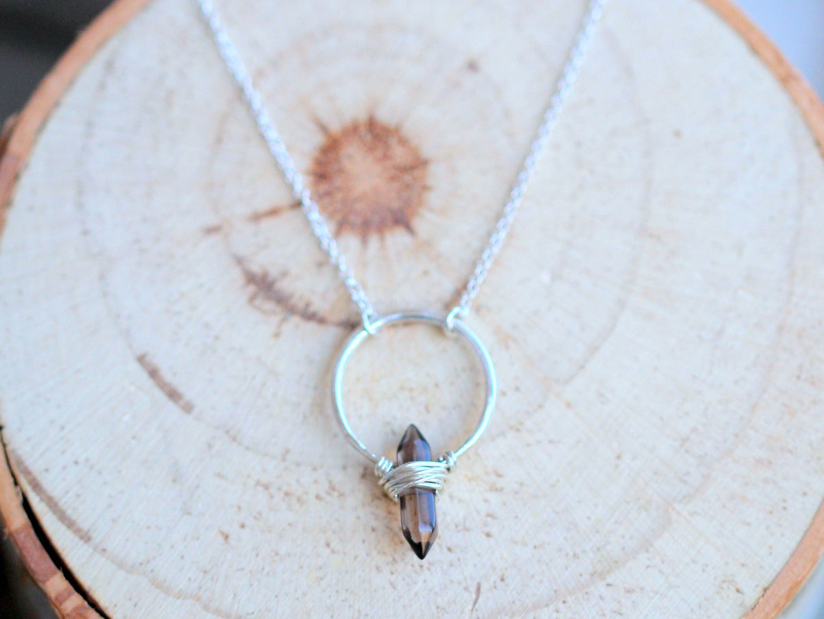 Crest necklace with smoky quartz stone and polished metal crest setting