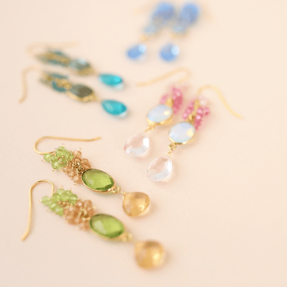 Bezel Cluster EarringsDripping in gems, these long gemstone drop earrings are a handmade combination of beautiful bezel set stones and clusters of gems.- 2.5" long- French hooks- 14k goldEarringsPARKEN JEWELRYVettedArcBezel Cluster Earrings