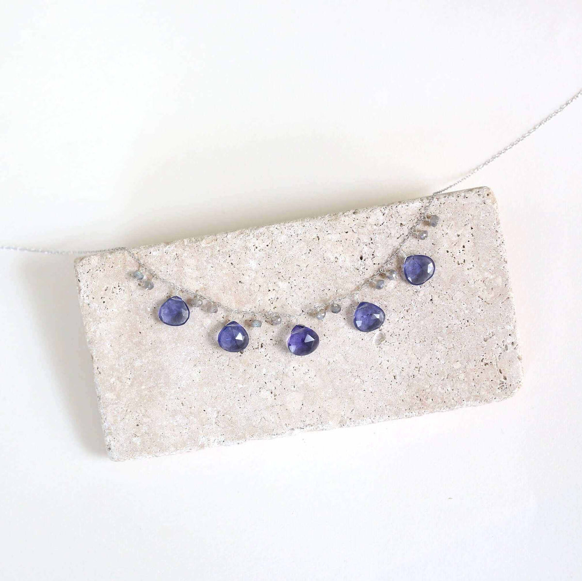 Tanzanite Quartz Silver Sparkler NecklaceA lovely string of sparkling gems.- Tanzanite Quartz & Labradorite gemstones- 16-18" long. Necklace has a 2" extender- Spring ring clasp- Rhodium plated .925 finNecklacesPARKEN JEWELRYVettedArcTanzanite Quartz Silver Sparkler Necklace