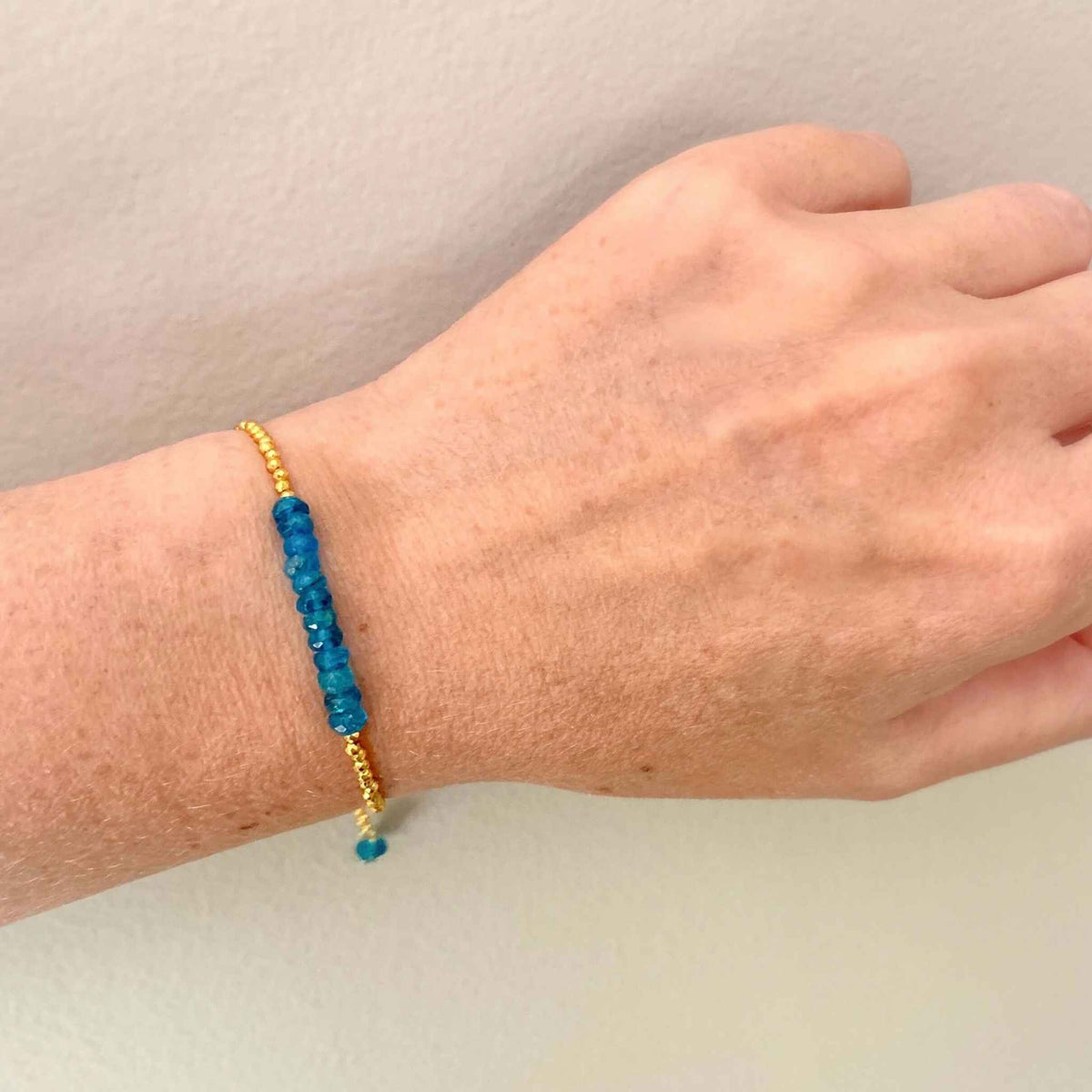 Neon Apatite Adjustable Stacking BraceletNeon Apatite Adjustable Stacking Bracelet — an authentic gemstone bracelet featuring neon blue apatite stones with gold accents. The adjustable slider clasp fiBraceletsPARKEN JEWELRYVettedArcneon blue apatite meaning