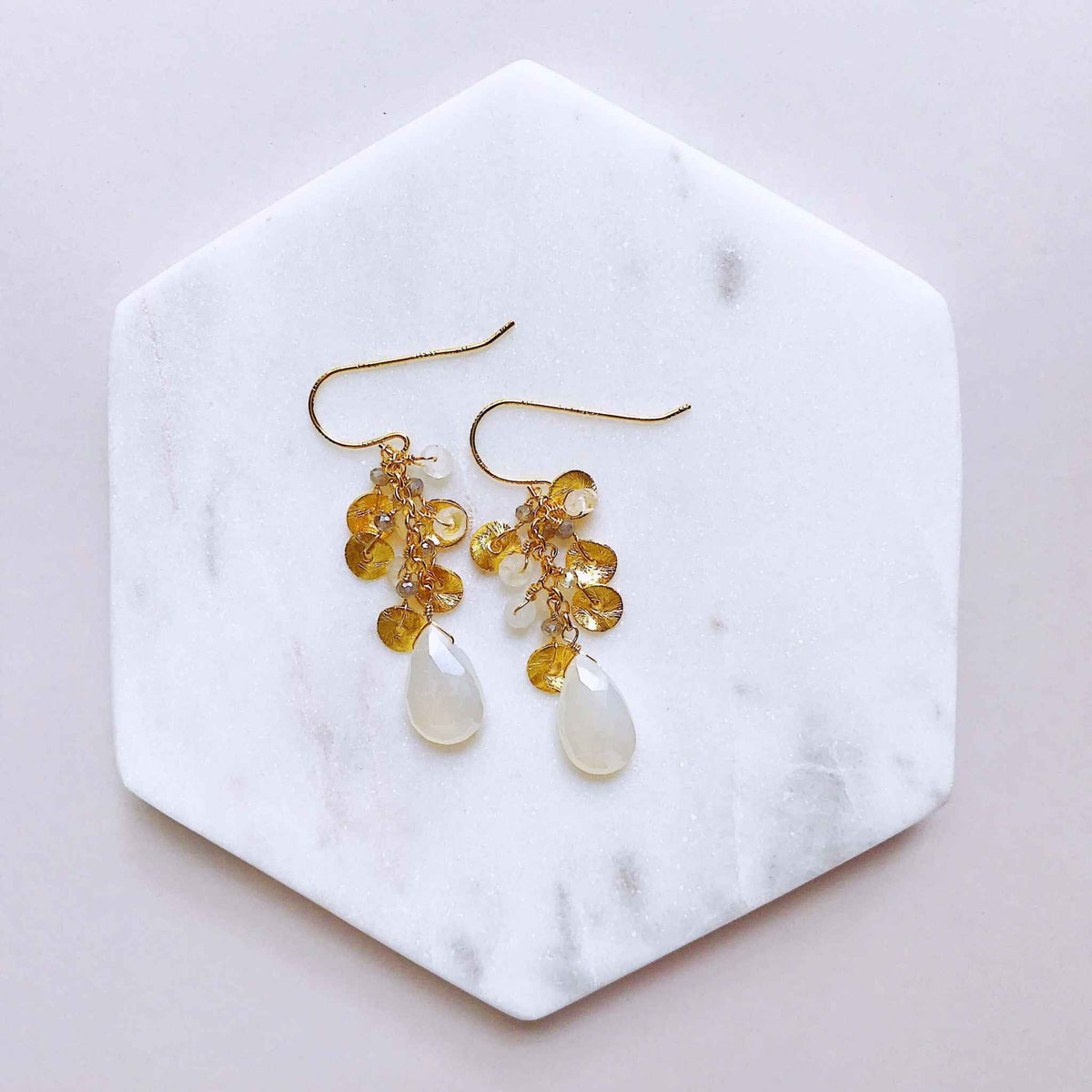 The Aurora Earring - White ChalcedonyBeautiful small gold earrings made with teardrop shaped white chalcedony gemstones and a cluster of gold and quartz gemstone accents.
- 1.5" long- French hooks
- 14kEarringsPARKEN JEWELRYVettedArcThe Aurora Earring