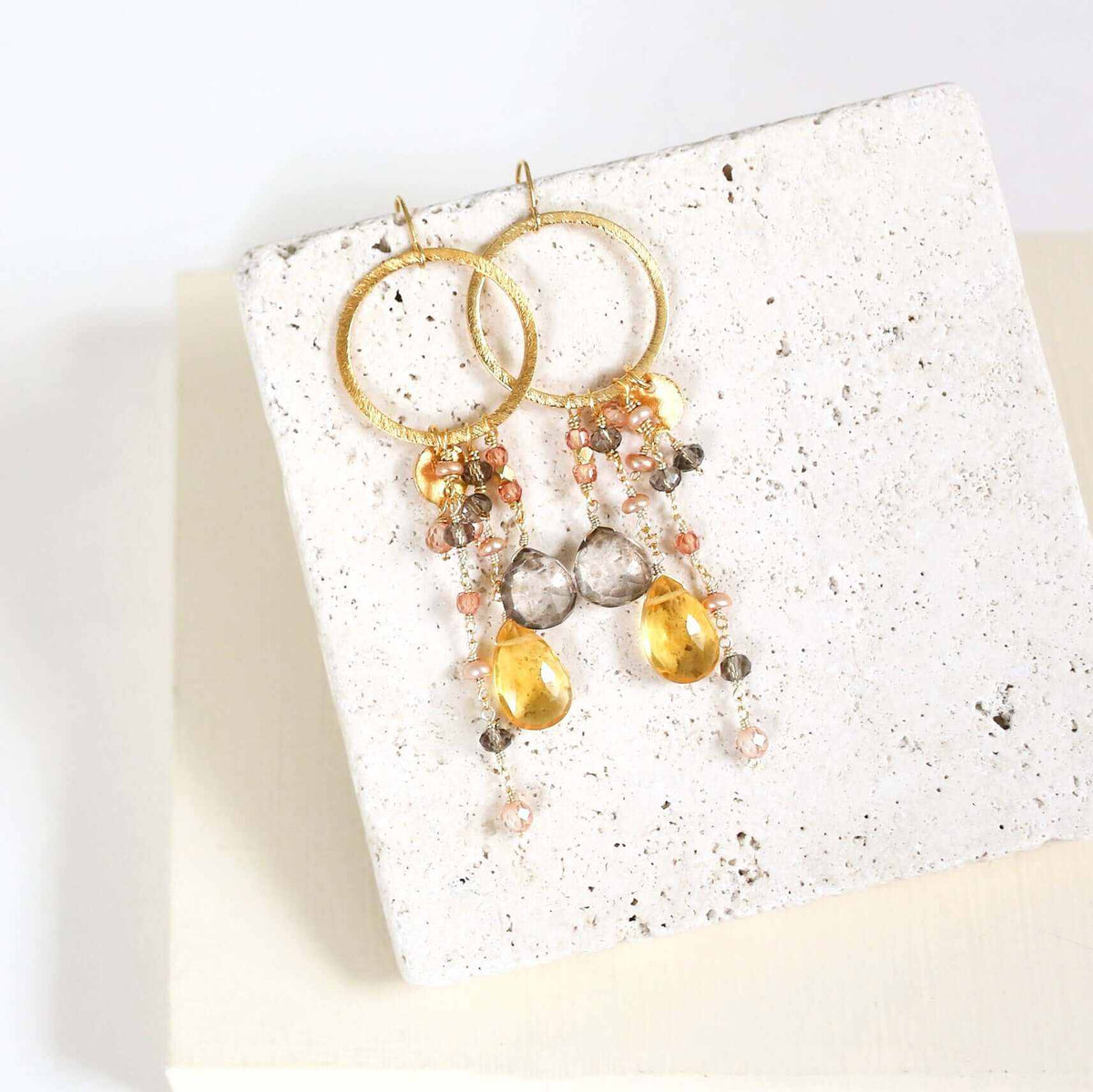 Amethyst & Citrine Ammil EarringsMultiple strands of lush gems sparkle on a 1" hoop.
- Amethyst and Citrine gemstones- 3.5" long- French hooks- 14k gold plated .925 fine Italian sterling silver- MadEarringsPARKEN JEWELRYVettedArcAmethyst & Citrine Ammil Earrings