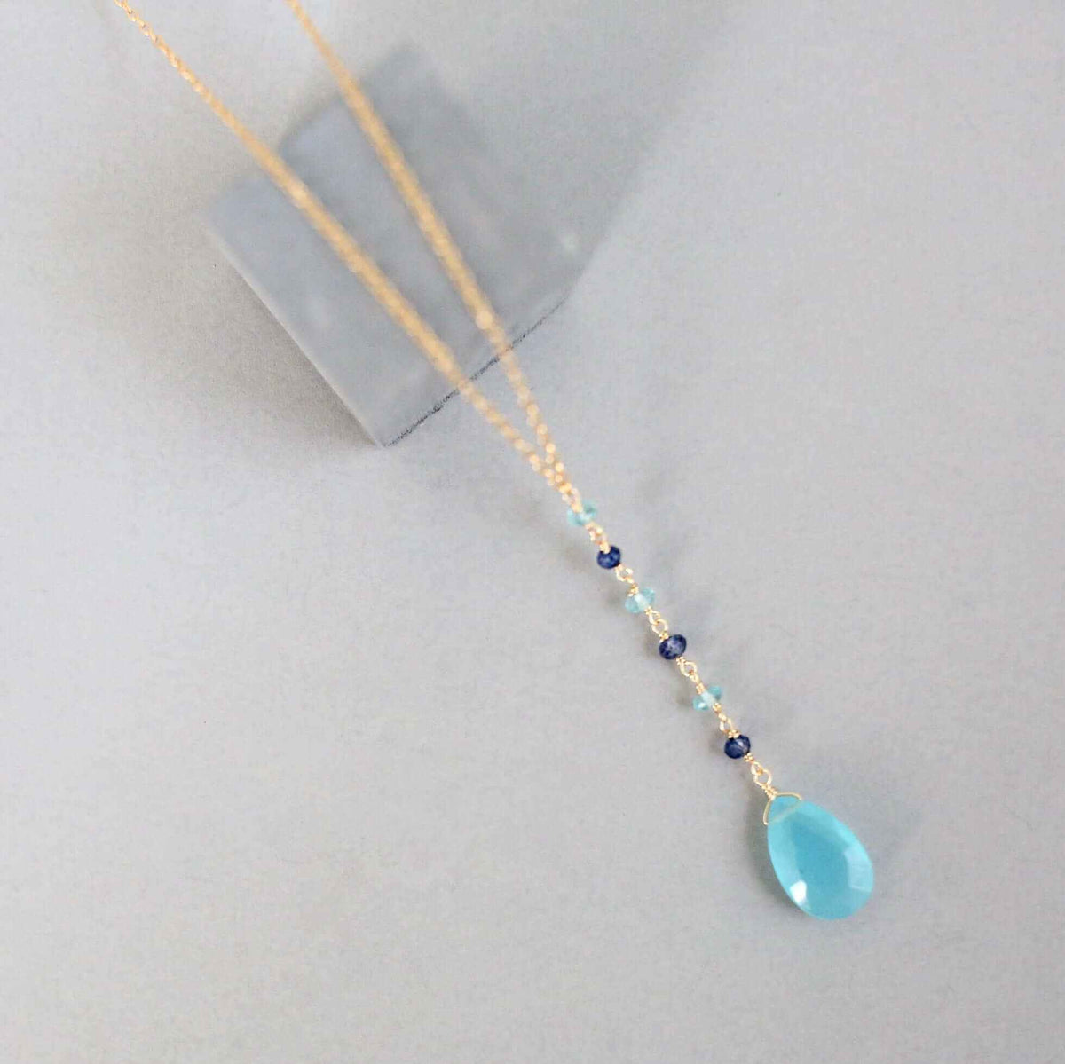 Blue Chalcedony Yoga PendantYoga pendants are designed for total simplicity.
- Blue Chalcedony gemstones paired with shades of blue gemstone accent stones- 18-20" long with a 2" extender chain-NecklacesPARKEN JEWELRYVettedArcBlue Chalcedony Yoga Pendant