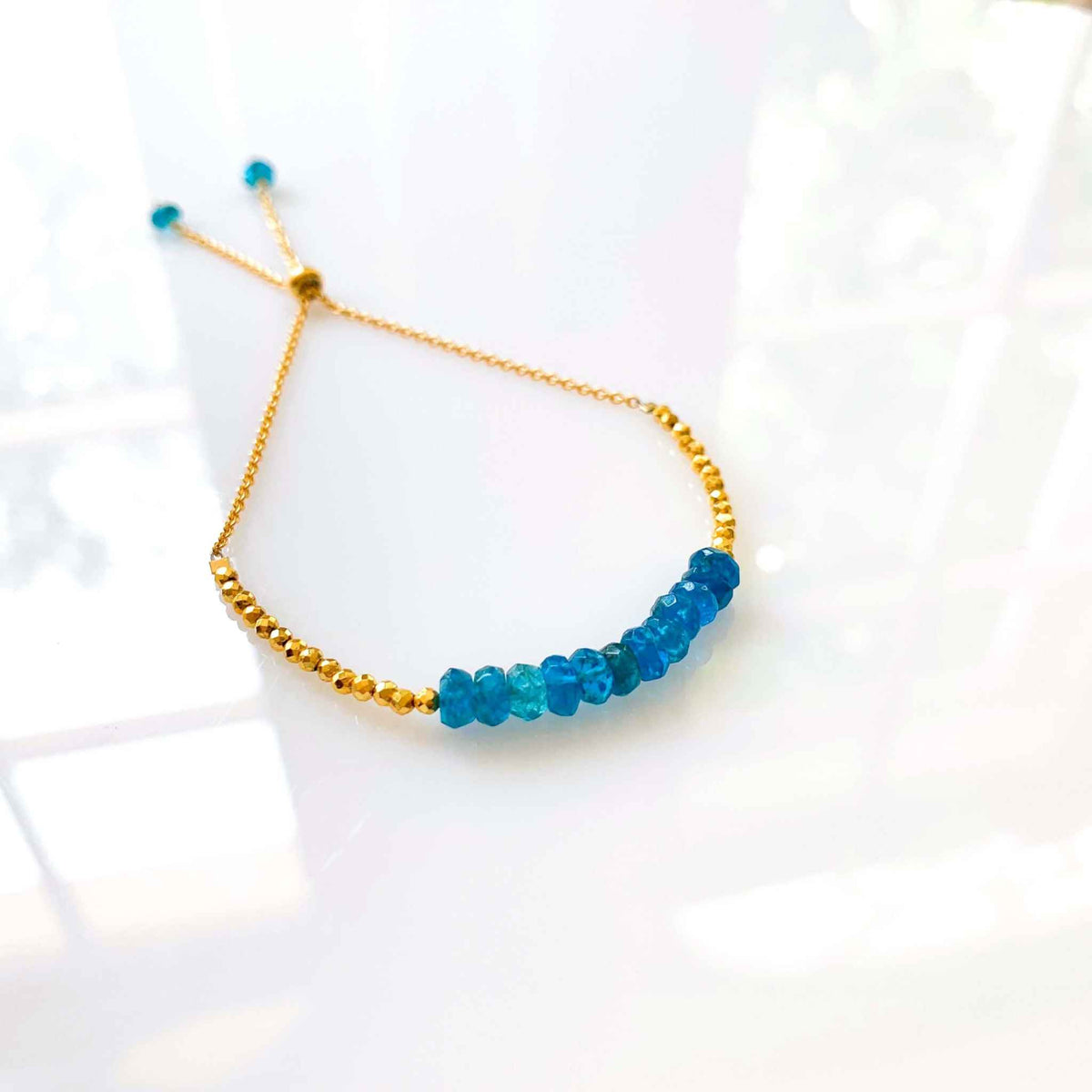 Neon Apatite Adjustable Stacking BraceletNeon Apatite Adjustable Stacking Bracelet — an authentic gemstone bracelet featuring neon blue apatite stones with gold accents. The adjustable slider clasp fiBraceletsPARKEN JEWELRYVettedArcneon blue apatite meaning