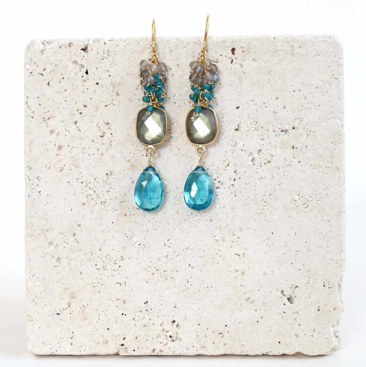 Bezel Cluster EarringsDripping in gems, these long gemstone drop earrings are a handmade combination of beautiful bezel set stones and clusters of gems.- 2.5" long- French hooks- 14k goldEarringsPARKEN JEWELRYVettedArcBezel Cluster Earrings