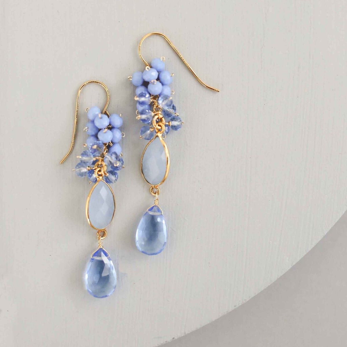 Bezel Cluster EarringsDripping in gems, these long gemstone drop earrings are a handmade combination of beautiful bezel set stones and clusters of gems.- 2.5" long- French hooks- 14k goldEarringsPARKEN JEWELRYVettedArcBezel Cluster Earrings