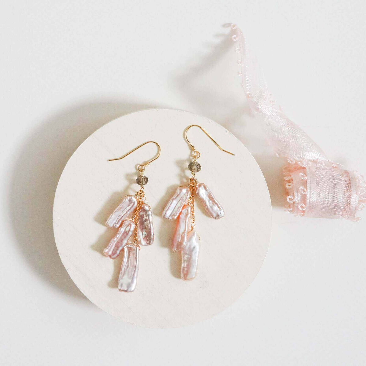 White stick pearl earrings with cascading freshwater pearls and black spinel accent on gold plated sterling silver French hooks