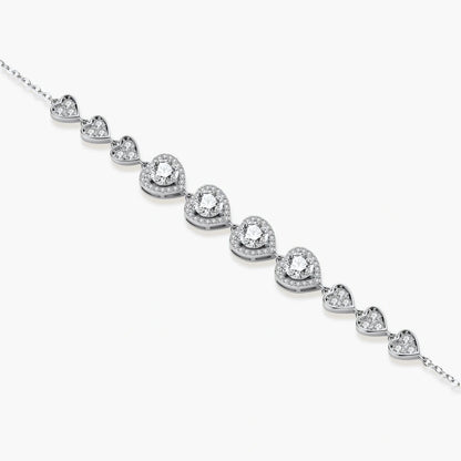 Sterling silver bracelet with graduated heart-shaped links and sparkling moissanite stones in VVS1 clarity on white background.