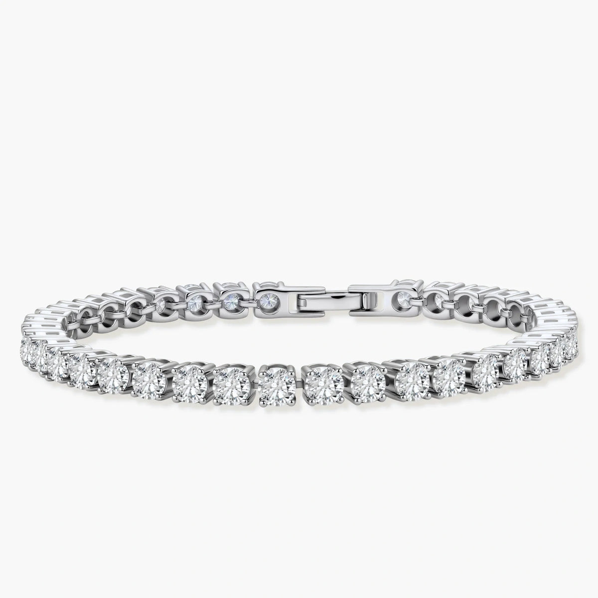 Sterling silver tennis bracelet with continuous row of brilliant moissanite stones and secure clasp closure on cream background.