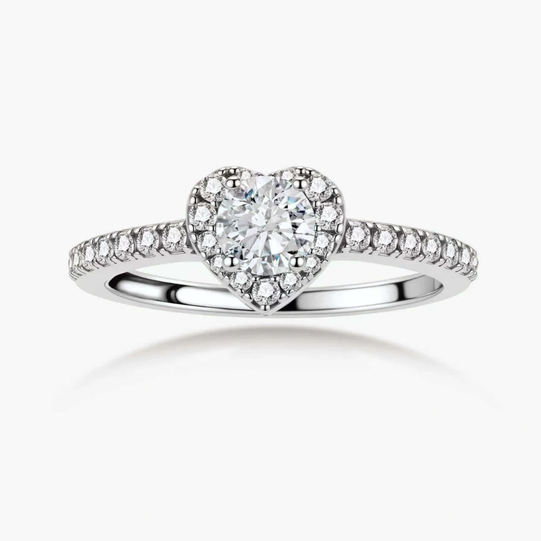 Heart-shaped halo ring with brilliant moissanite center stone surrounded by smaller crystals in sterling silver setting