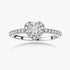 Heart-shaped halo ring with brilliant moissanite center stone surrounded by smaller crystals in sterling silver setting