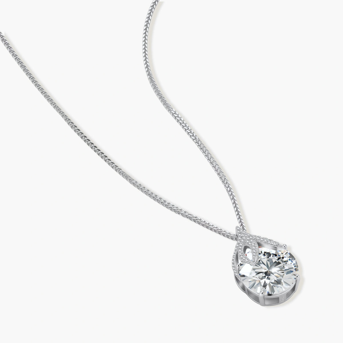Sterling silver necklace featuring a large pear-shaped moissanite stone in an ornate setting with smaller accent stones