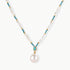 Beaded necklace with baroque pearls, turquoise stones, and gold accents featuring a large pearl pendant on white background.