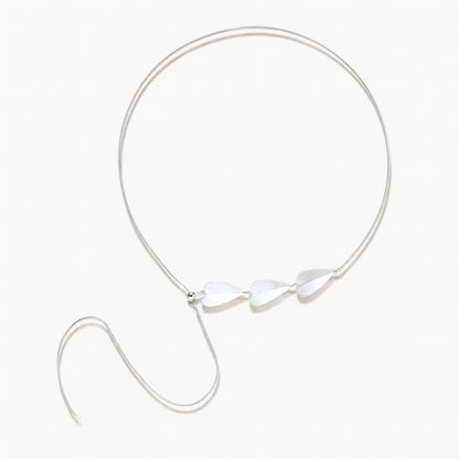 Minimalist sterling silver necklace with three brushed leaf-shaped pendants on delicate chain against white background