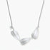 Minimalist sterling silver necklace with three brushed leaf-shaped pendants on delicate chain against white background