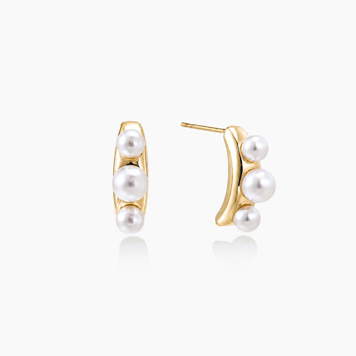 14K gold-plated curved stud earrings with three white freshwater pearls aligned vertically on cream background