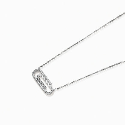 White gold plated necklace with dual-frame geometric pendant featuring crystal pavé border on pale background.