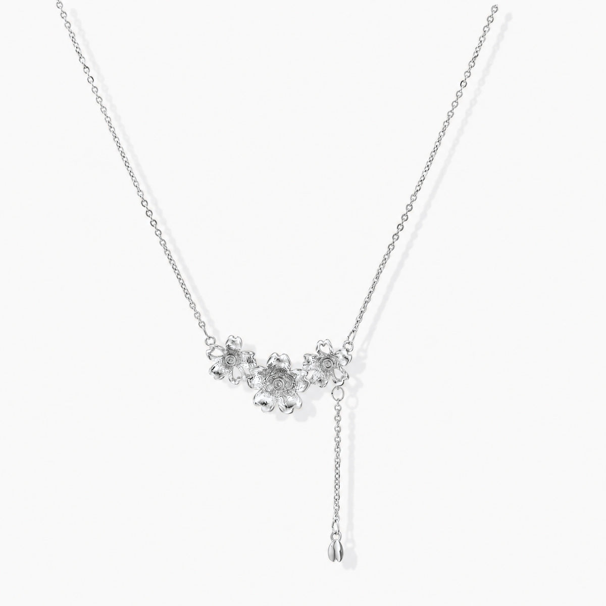 White gold plated Y-shaped necklace with three dimensional flower charms and adjustable drop pendant