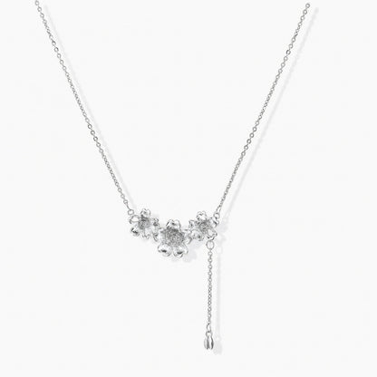 White gold plated Y-shaped necklace with three dimensional flower charms and adjustable drop pendant