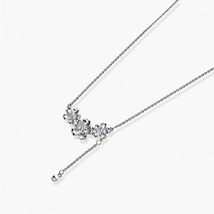 White gold plated Y-shaped necklace with three dimensional flower charms and adjustable drop pendant