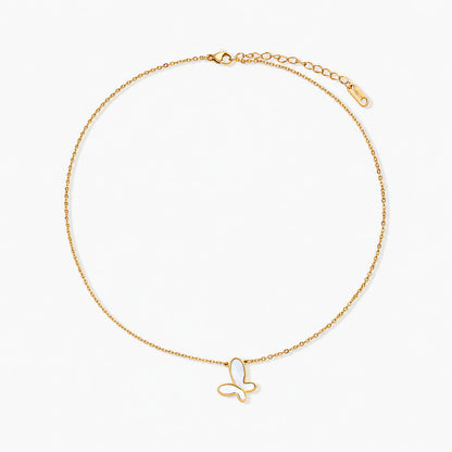 Gold-plated butterfly pendant with iridescent mother of pearl inlay on delicate chain against cream background.