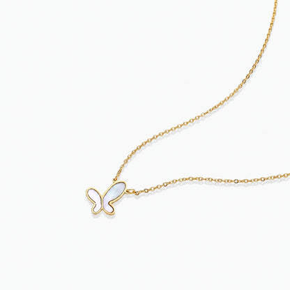 Gold-plated butterfly pendant with iridescent mother of pearl inlay on delicate chain against cream background.