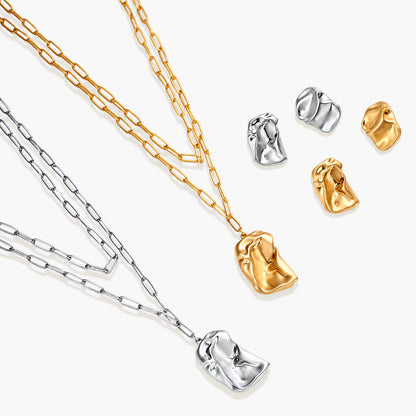Modern textured hoop earrings and layered chain necklace with liquid metal pendant in silver and gold finishes.