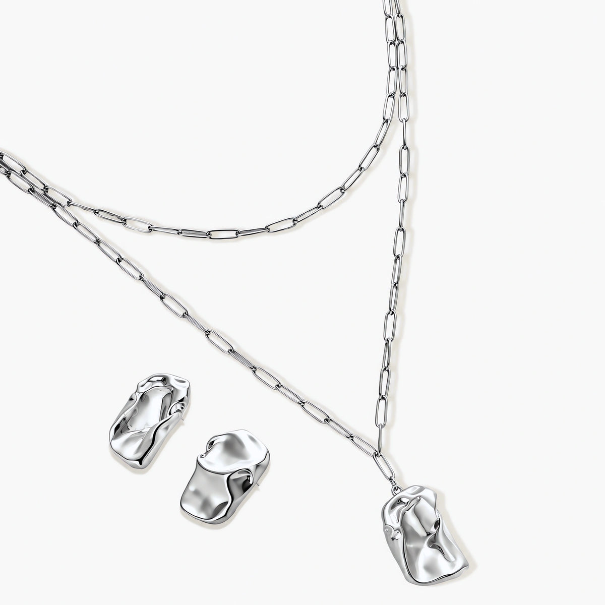 Modern textured hoop earrings and layered chain necklace with liquid metal pendant in silver and gold finishes.