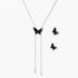 Dark wood butterfly earrings and necklace with silver chain accents on white background, showing natural grain texture.