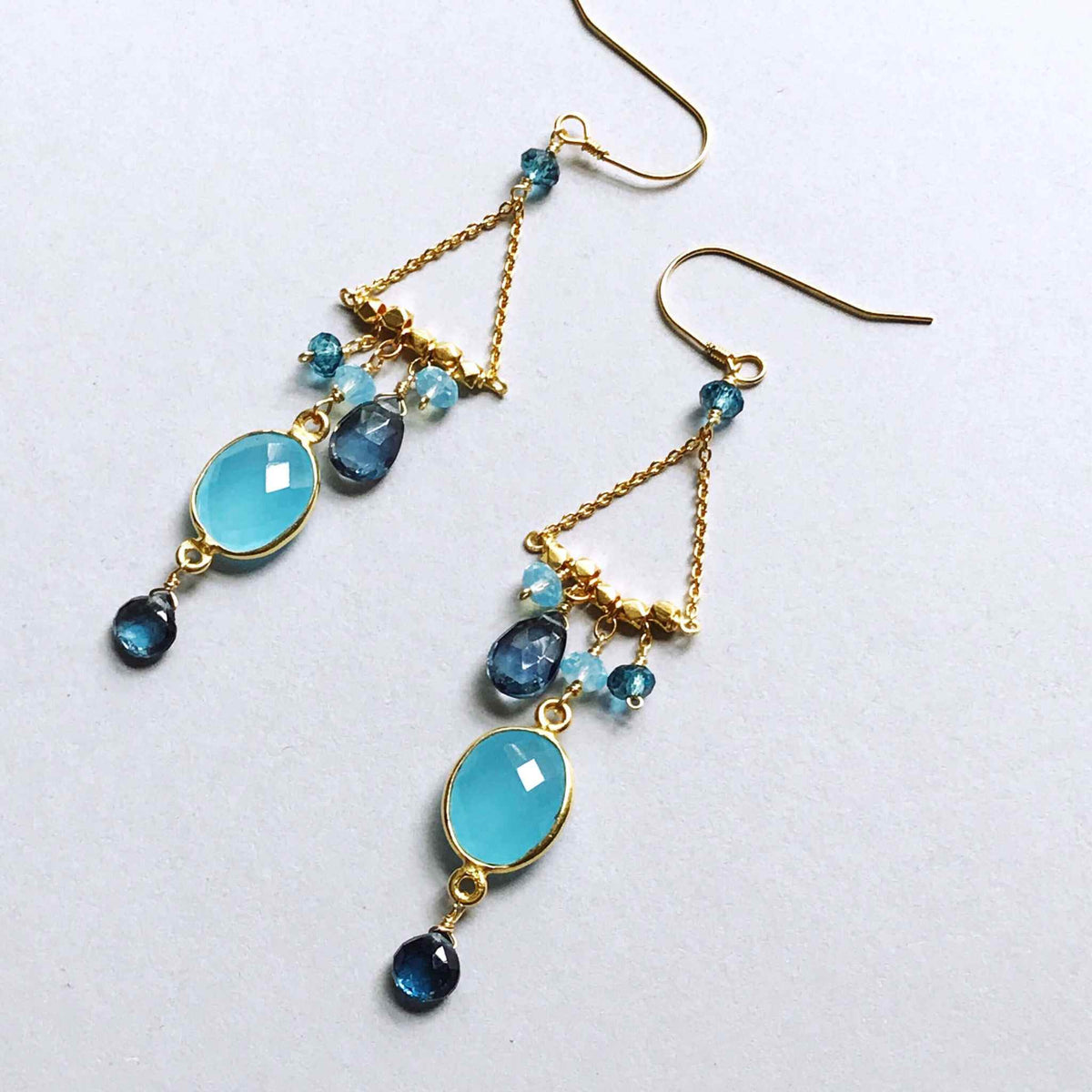 Blue Chandie EarringsOur "chandies" are a modern take on classic chandelier earrings, using gemstone color combos and different stone shapes and sizes.
- Bezel set blue chalcedony gemstoEarringsPARKEN JEWELRYVettedArcBlue Chandie Earrings