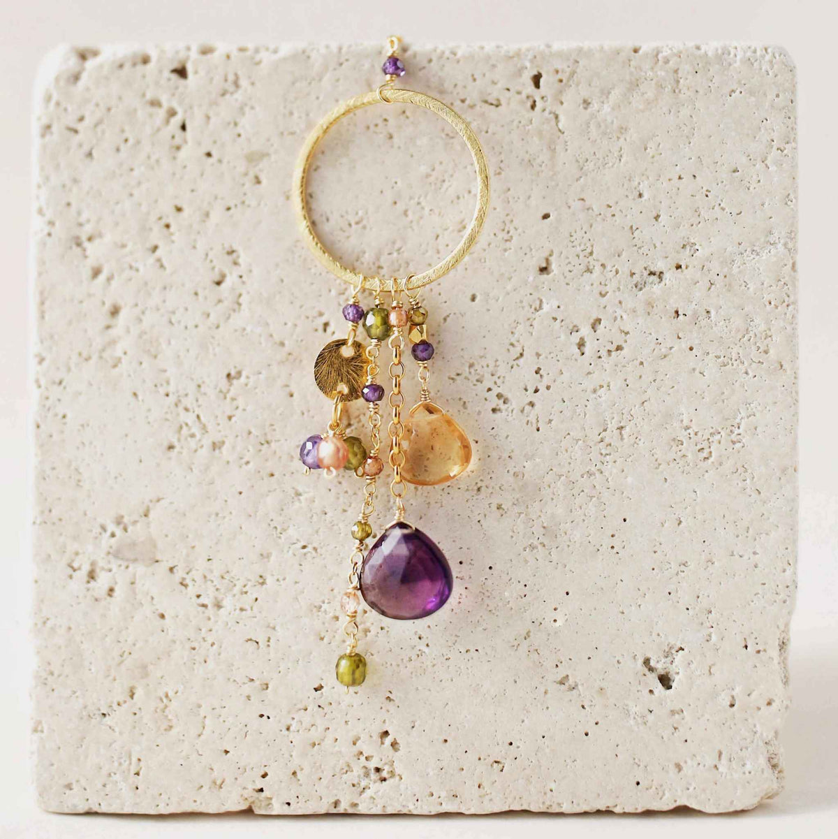 The Ammil Necklace - Amethyst &amp; CitrineThe ultimate gemstone pendant. Multiple strands of glimmering amethyst, citrine and peridot gemstones hang from our signature gold circle. Handmade with 14k gold plaNecklacesPARKEN JEWELRYVettedArcThe Ammil Necklace