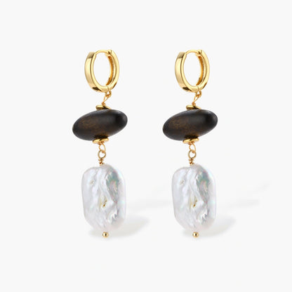 Gold hoop earrings with dark wood beads and baroque freshwater pearls, shown from multiple angles on cream background.