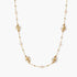 Long gold chain necklace with baroque pearls wrapped in leaf designs and small freshwater pearls spaced along the strand