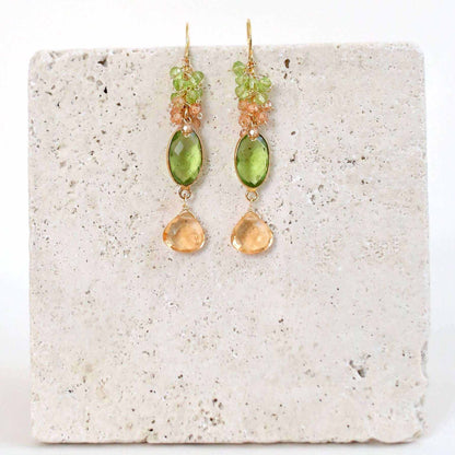 Bezel Cluster EarringsDripping in gems, these long gemstone drop earrings are a handmade combination of beautiful bezel set stones and clusters of gems.- 2.5" long- French hooks- 14k goldEarringsPARKEN JEWELRYVettedArcBezel Cluster Earrings
