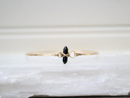 Obsidian crest bracelet with black polished stone beads and a crest accent, unisex design
