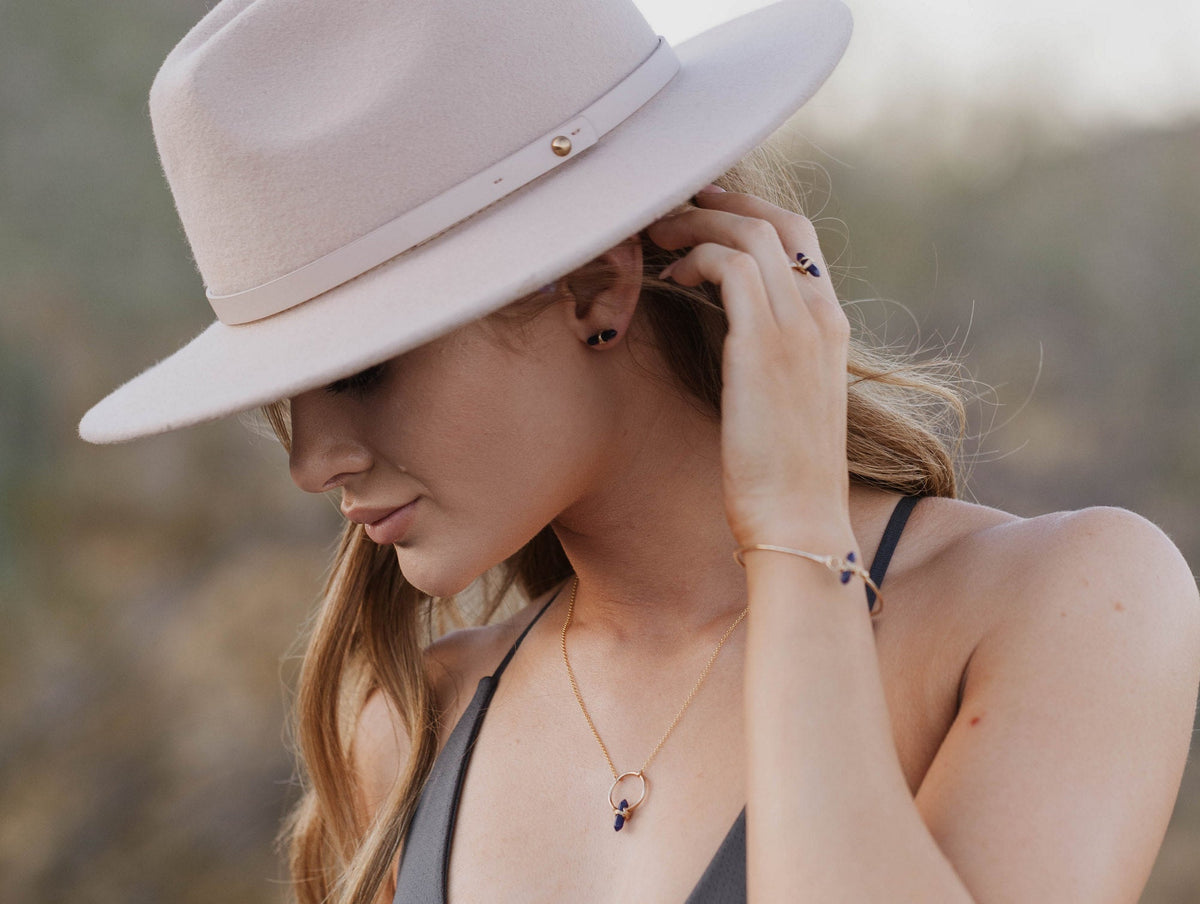 Crest necklace in smoky quartz worn on neck, warm brown gemstone drop
