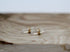 Clear crystal-like objects with gold bands on a wooden surface