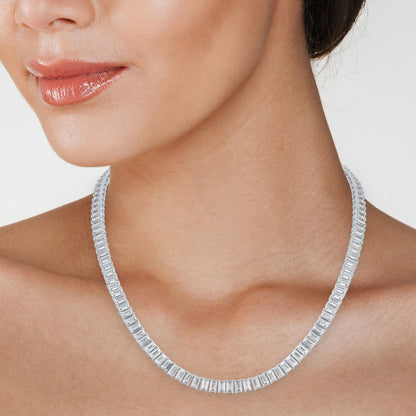 Close-up of emerald-cut moissanite stones on a 14K gold overlay tennis necklace