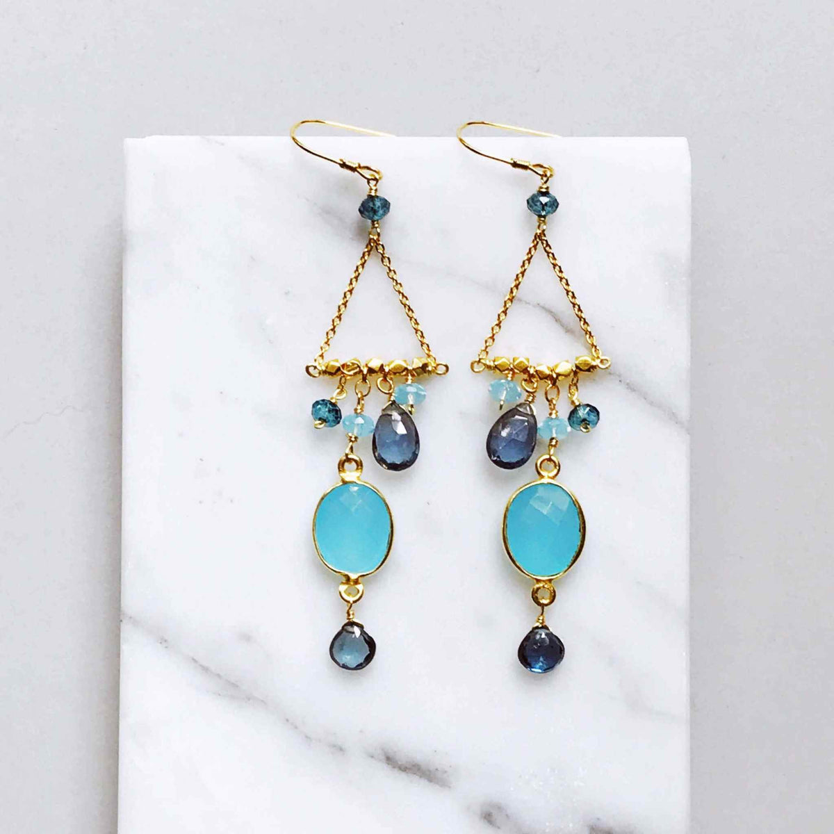 Blue Chandie EarringsOur "chandies" are a modern take on classic chandelier earrings, using gemstone color combos and different stone shapes and sizes.
- Bezel set blue chalcedony gemstoEarringsPARKEN JEWELRYVettedArcBlue Chandie Earrings