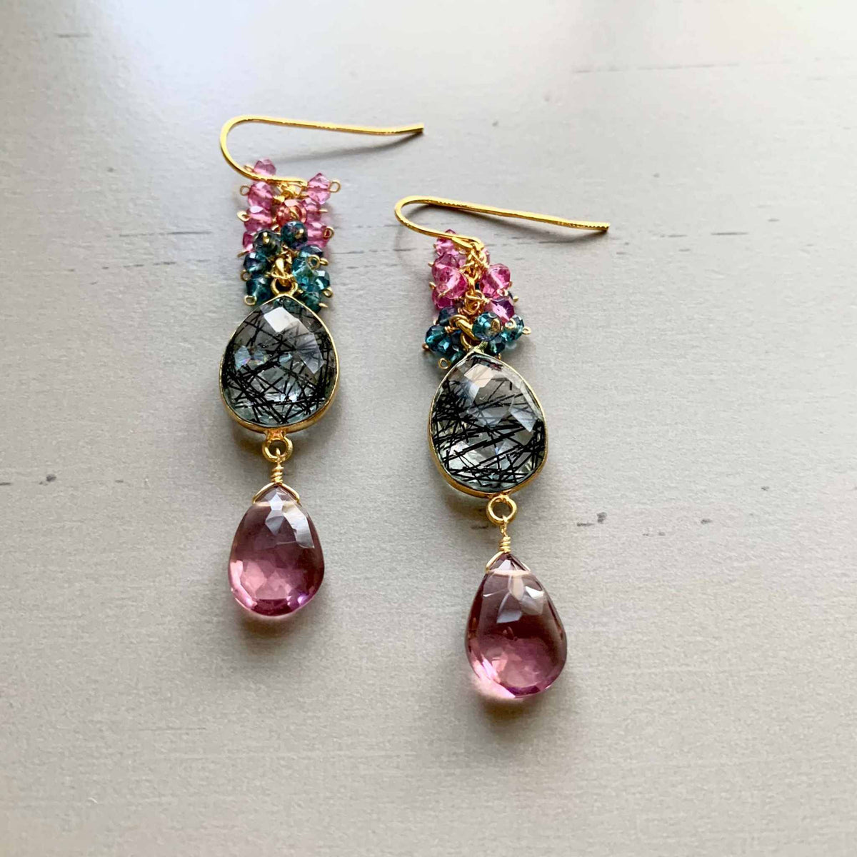 Pink Rhodolite Garnet And Rutilated Quartz Bezel Cluster EarringsGauranteed to get attention, these long gemstone drop earrings are made with dazzling pink rhodolite garnet gems and black rutilated quartz bezel stones.- 2.5" long-EarringsPARKEN JEWELRYVettedArcPink Rhodolite Garnet