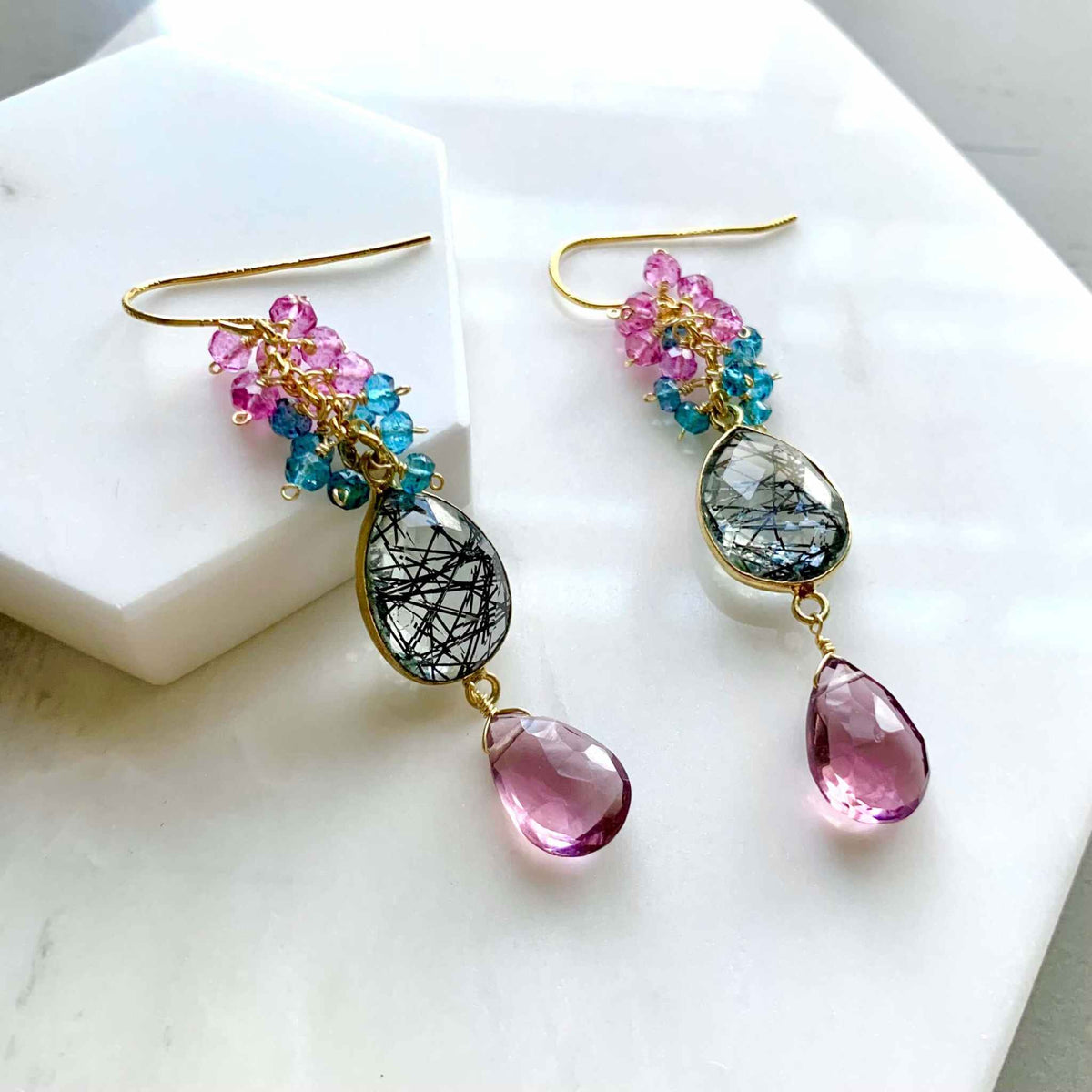 Pink Rhodolite Garnet And Rutilated Quartz Bezel Cluster EarringsGauranteed to get attention, these long gemstone drop earrings are made with dazzling pink rhodolite garnet gems and black rutilated quartz bezel stones.- 2.5" long-EarringsPARKEN JEWELRYVettedArcPink Rhodolite Garnet