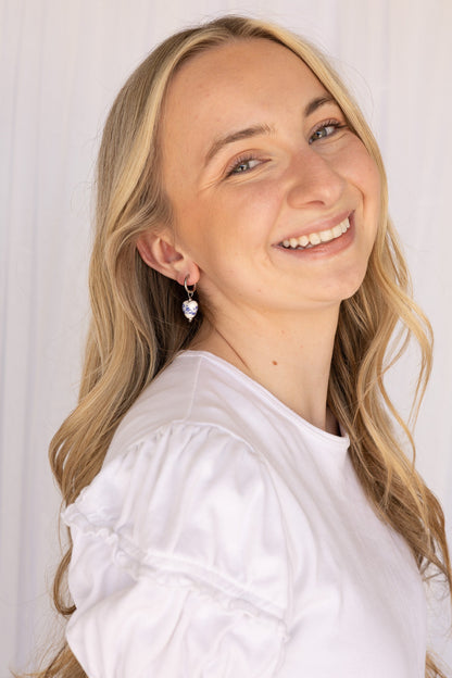 Close-up of a blue hoop earring highlighting the glossy finish