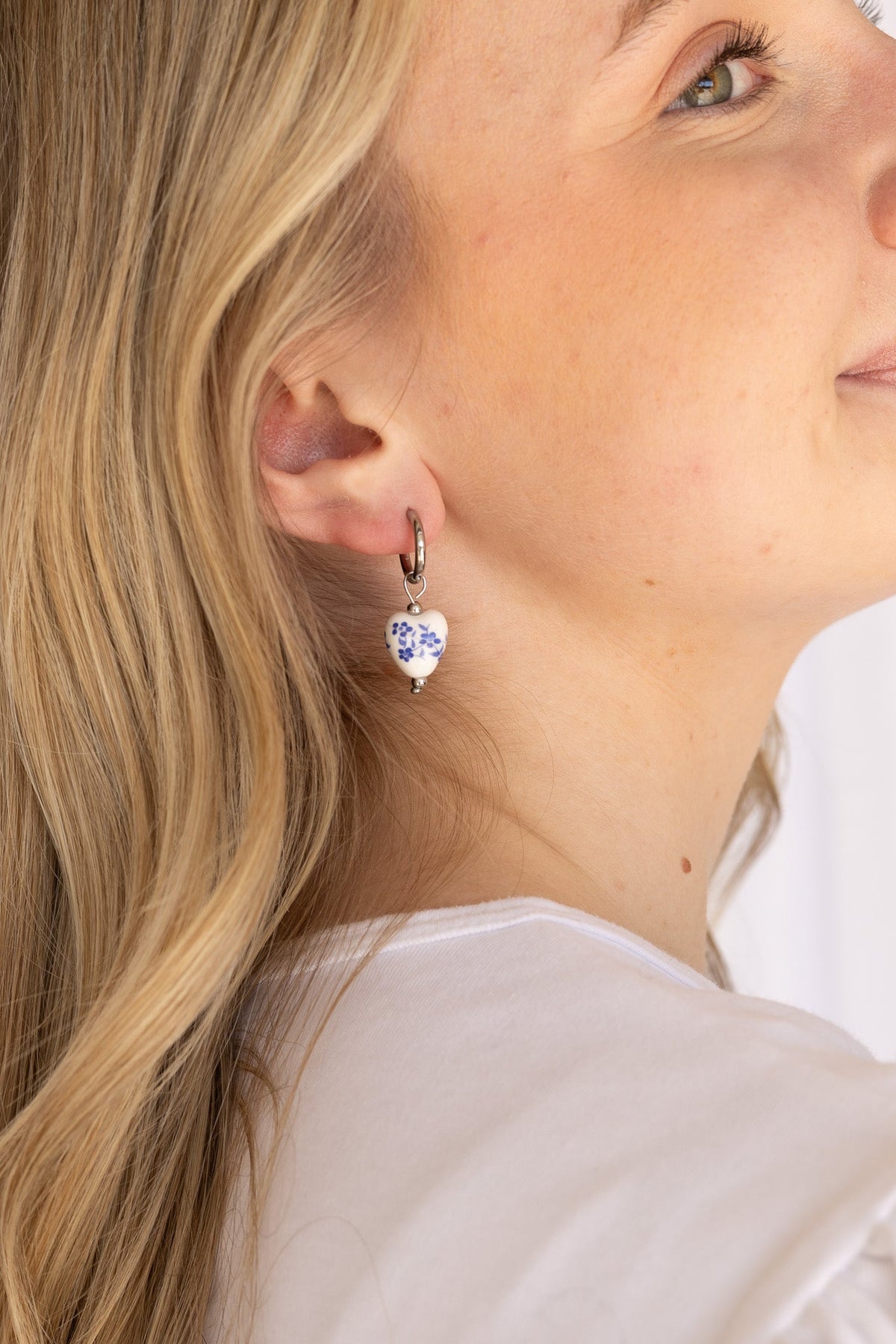 Model wearing a blue hoop earring, styled for everyday wear