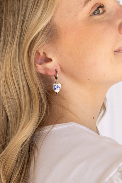 Model wearing a blue hoop earring, styled for everyday wear