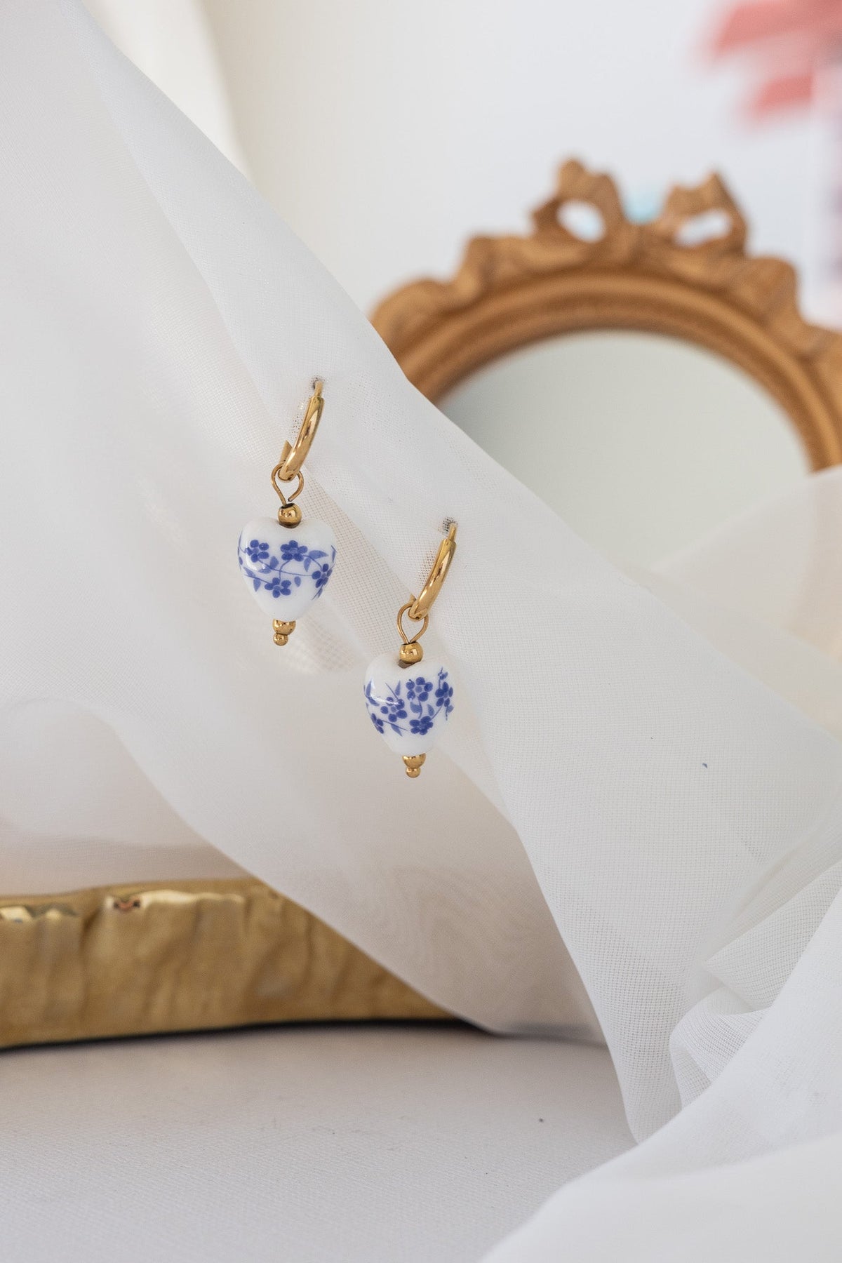 Blue hoop earrings displayed flat, showing the circular silhouette