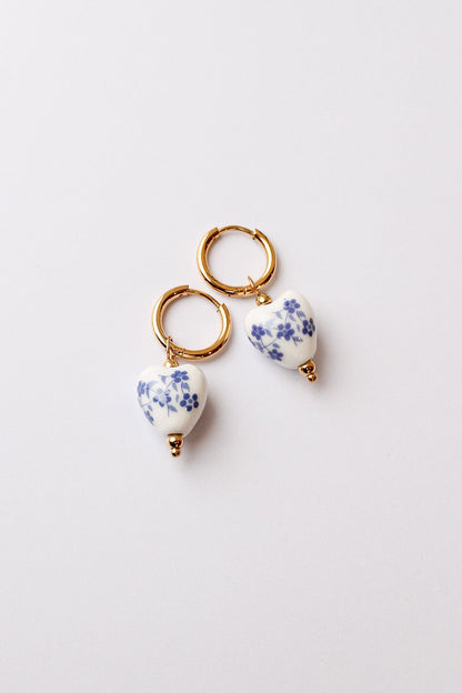 Blue hoop earring with a polished round shape, shown as a single earring